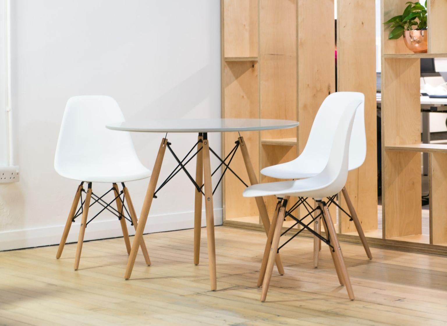 round glass-top table near shelf